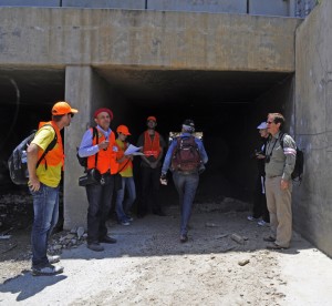 Conference organizer and "coyote" Oscar Romo, directing participants through the culvert at Goat Canyon